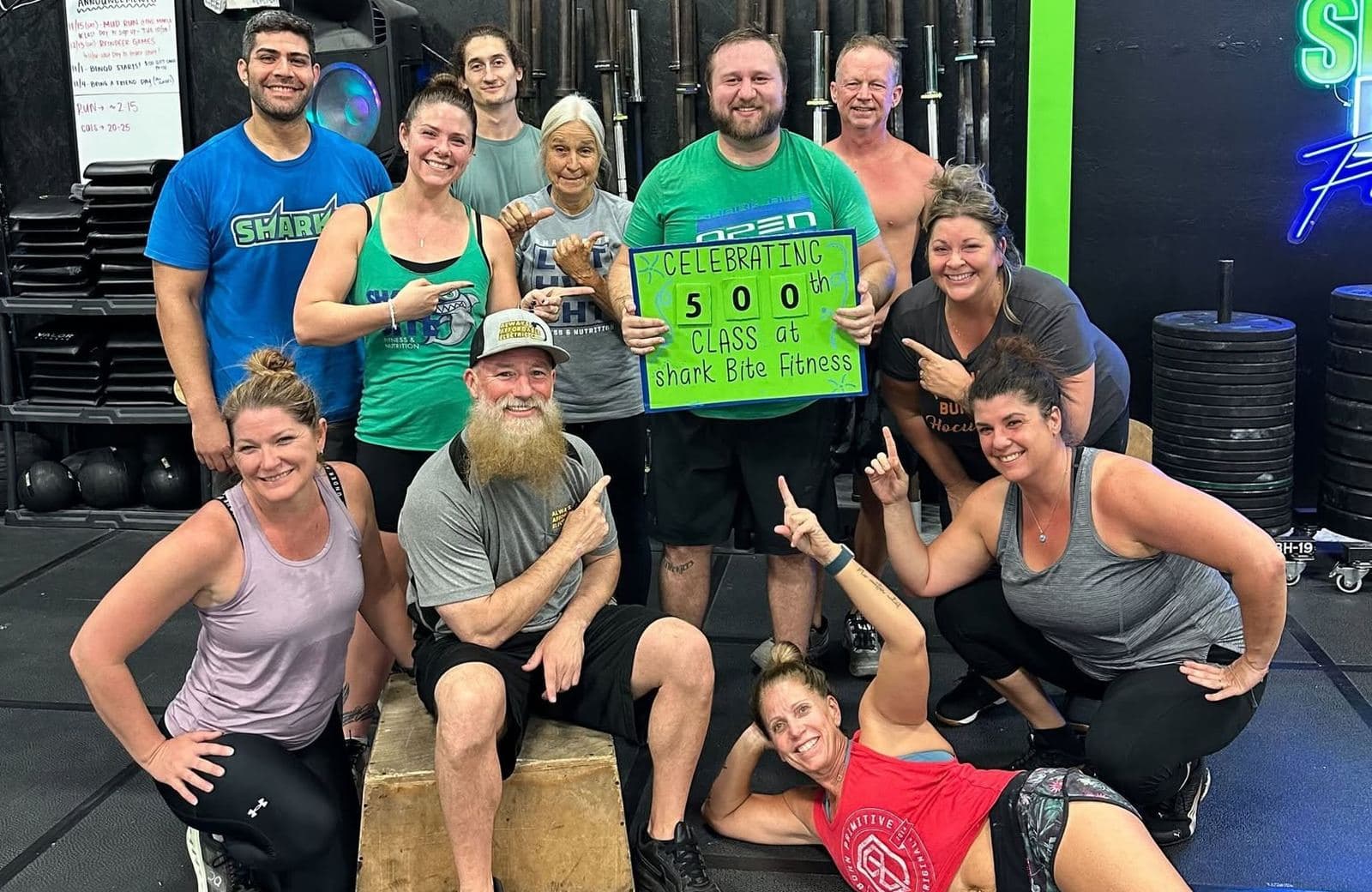 Members celebrating a 500th class at Shark Bite Fitness